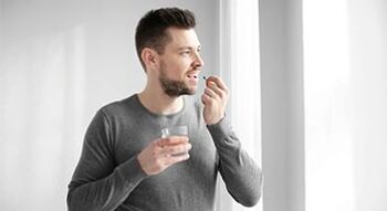 A man is taking medication to treat prostatitis